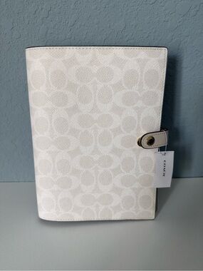 Brand new white coach notebook.